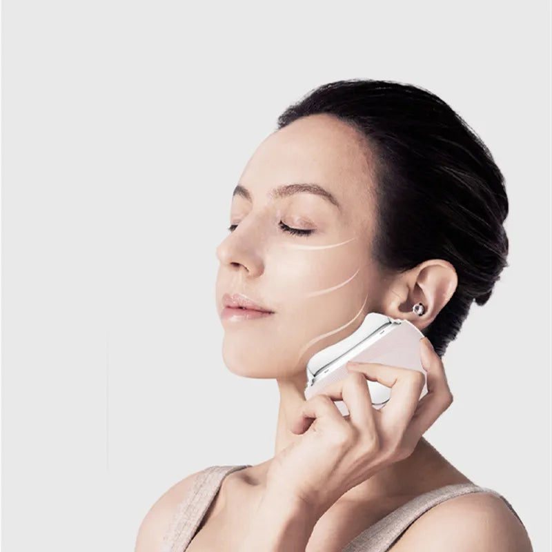 Woman using a skincare device on her face against a light background